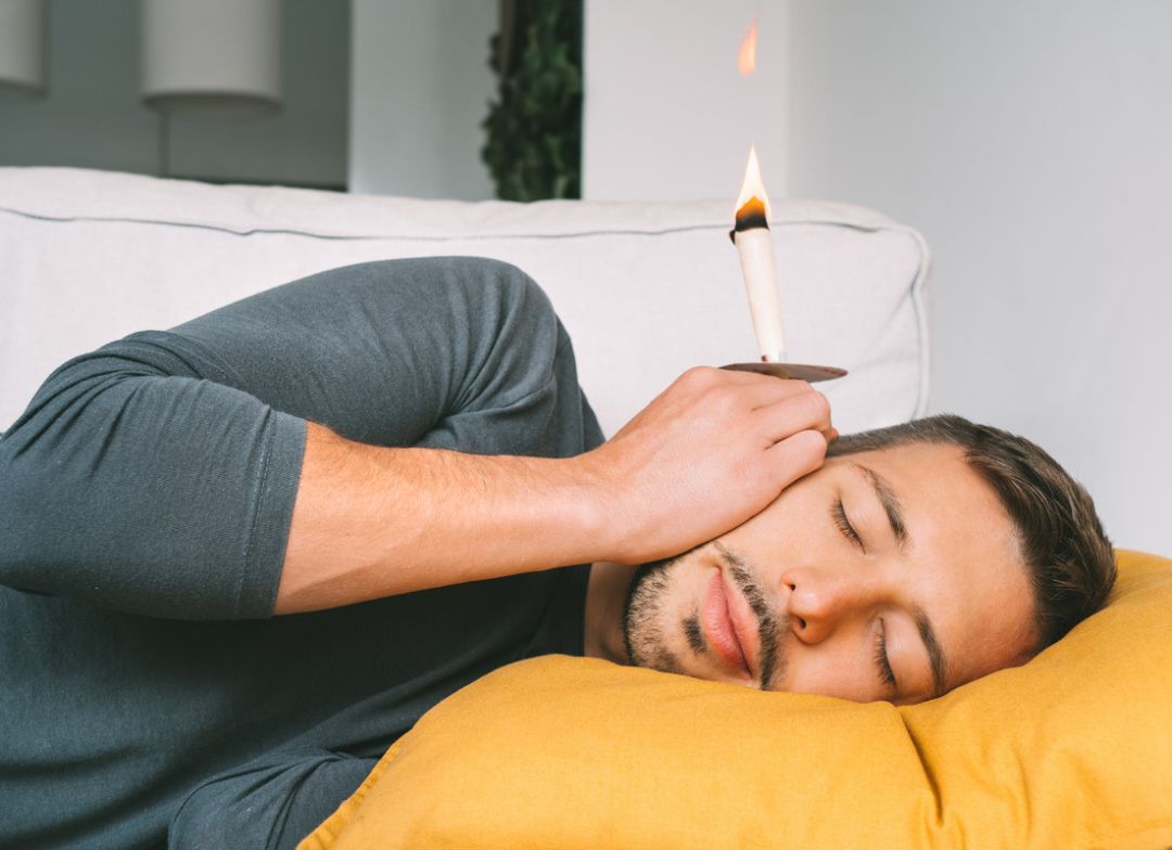 Man using Earwax Candles