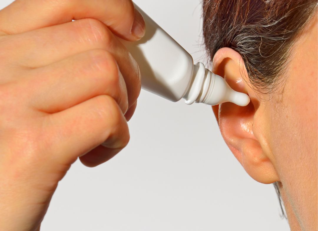 Place the earwax removal injection into the ear