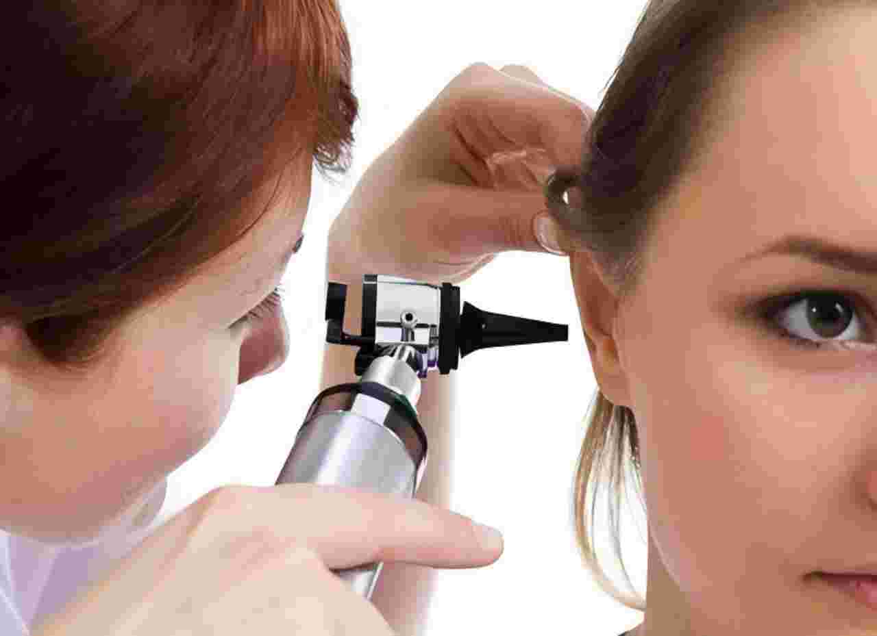 Ears are being cleaned with specialized equipment.